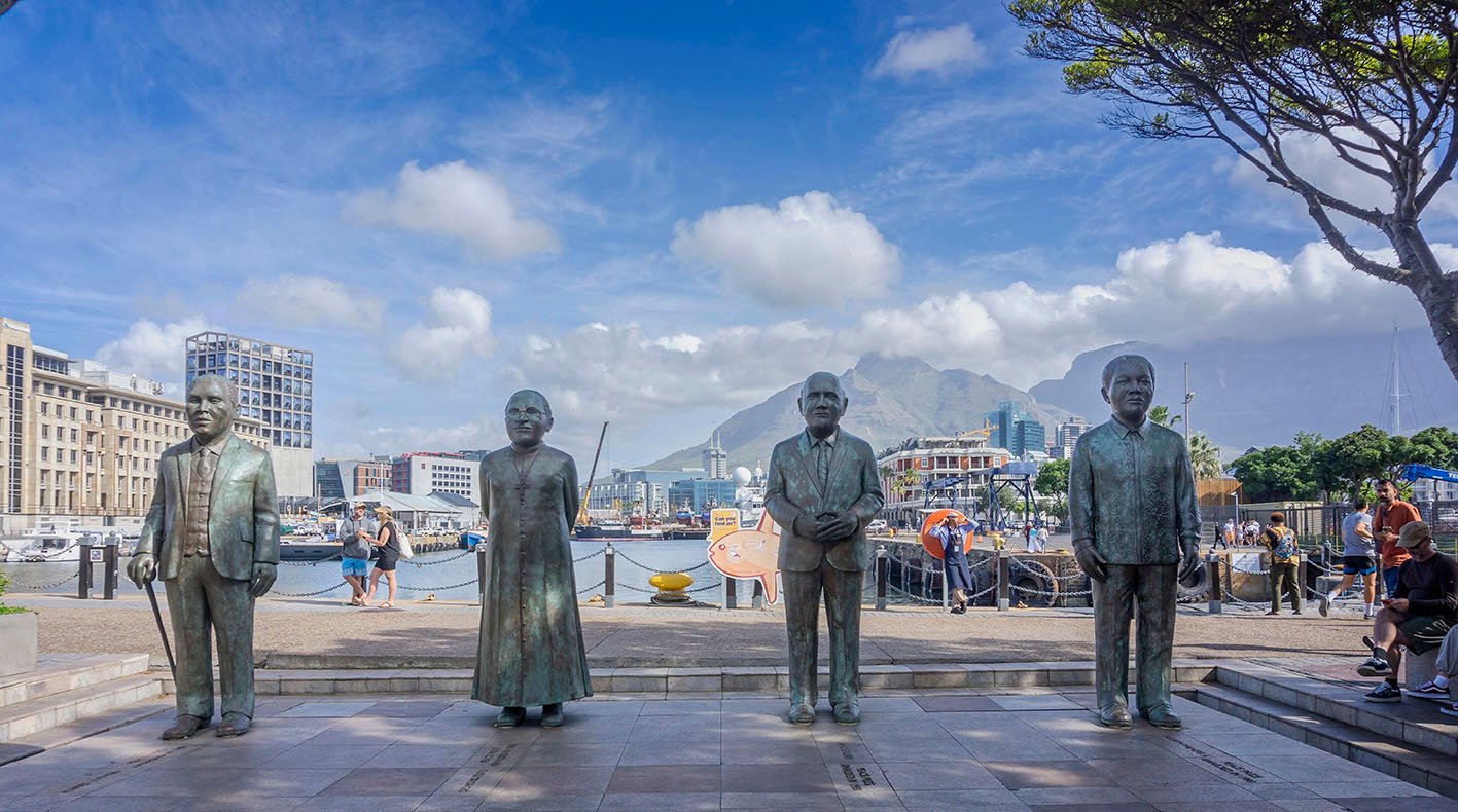 Bronze-statue-nobel-vanda-capetown Bronze sculptures of the four Nobel Peace Prize laureates, Nelson Mandela, FW de Klerk, Desmond Tutu and Alfred Luthuli, infront of Table Mountain, at Nobel Square, in the V&A Waterfront in Cape Town, South Africa on 5 December 2024