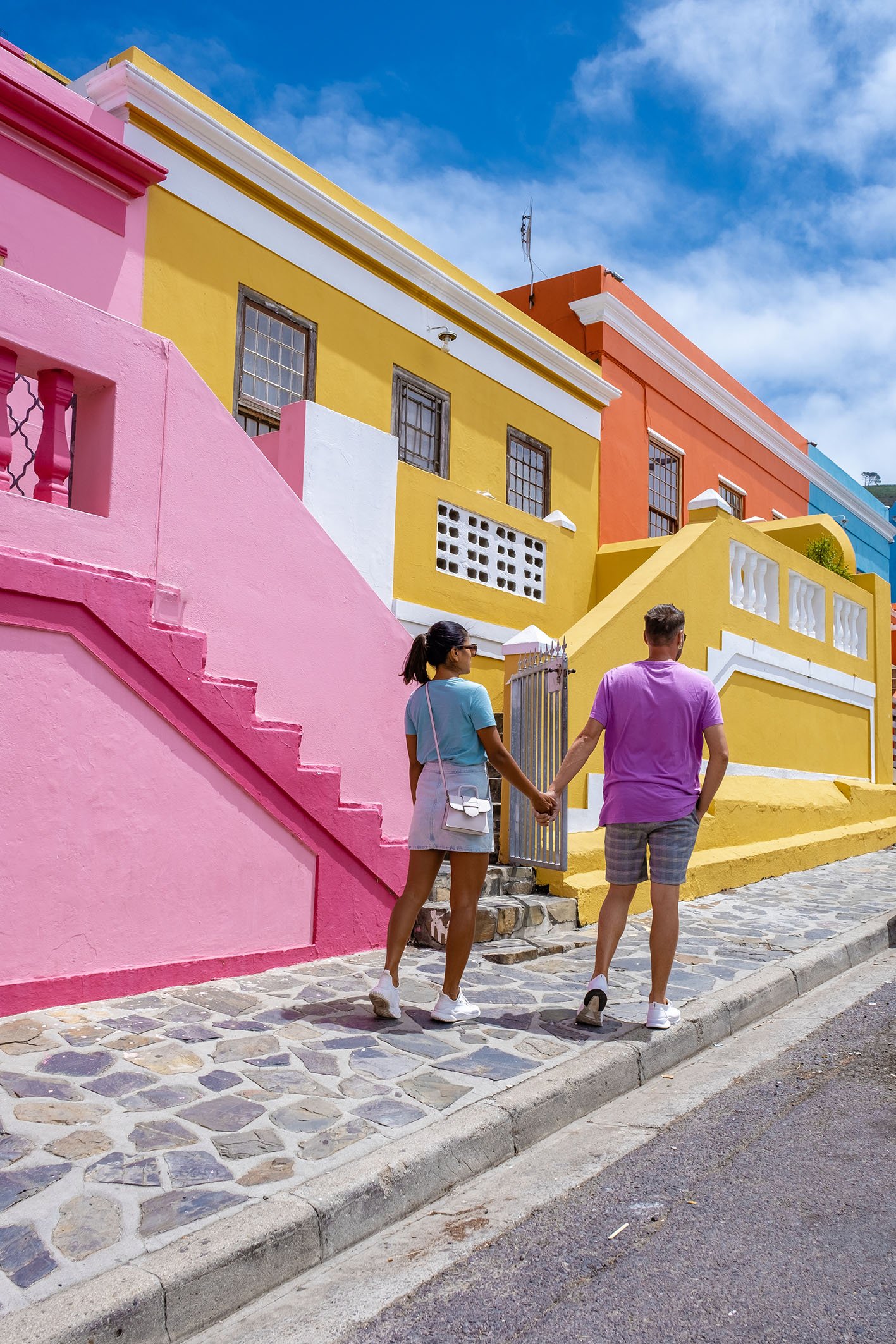 Bo Kaap Township in Cape Town, colorful house in Cape Town South Africa. Bo Kaap, couple man and woman on a city trip in Cape Town Bo Kaap Township in Cape Town, colorful house in Cape Town South Africa. Bo Kaap, couple man and woman on a city trip in Cape Town